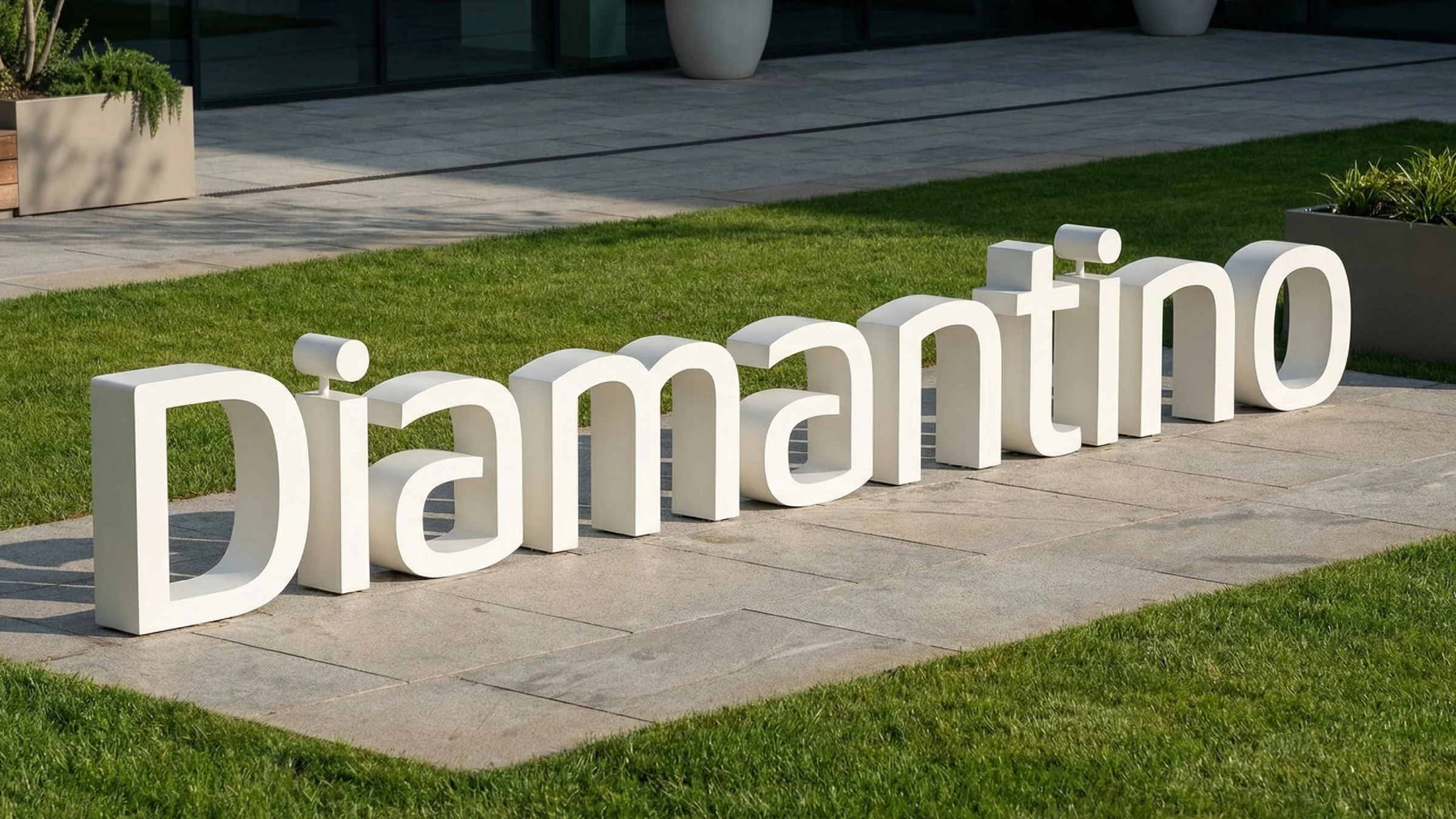 Diamantino logo letters in white 3D on a lawn
