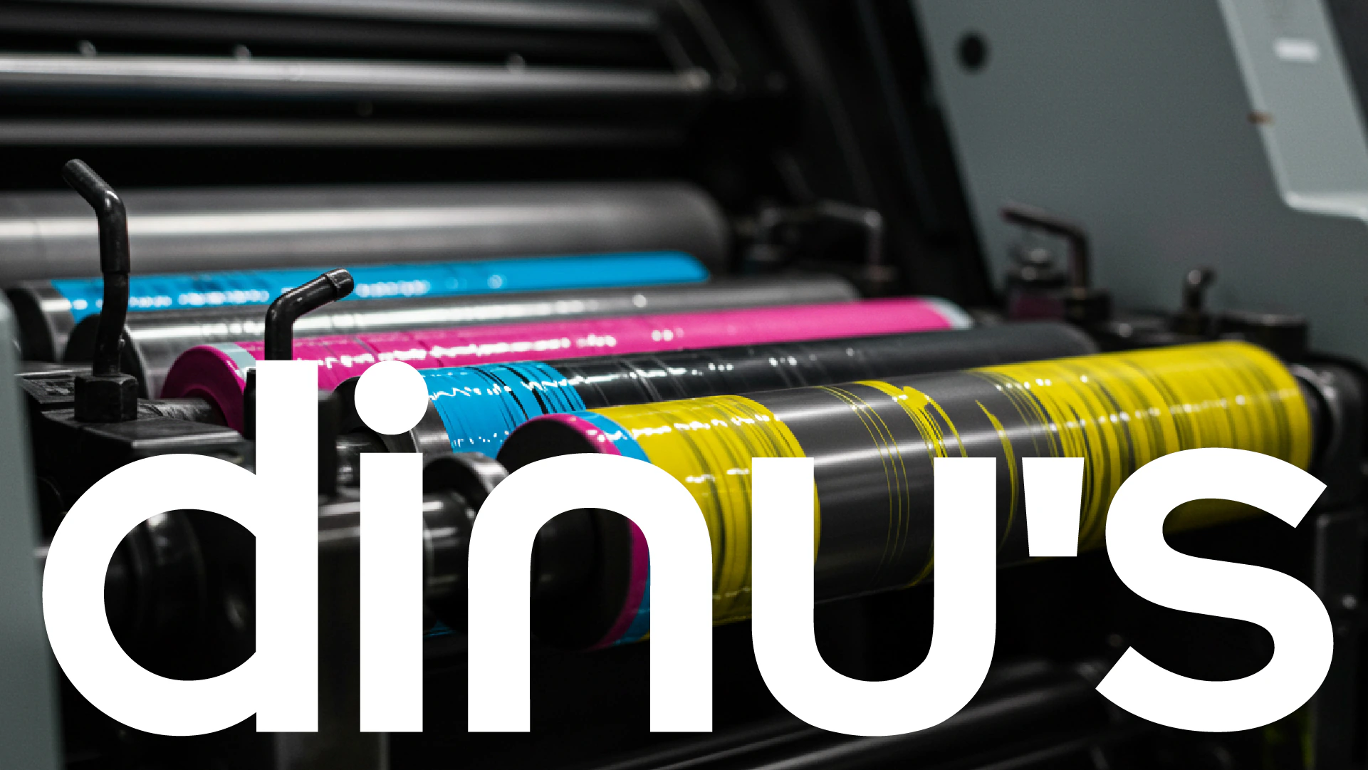DINU’S logo at large scale on a printing press