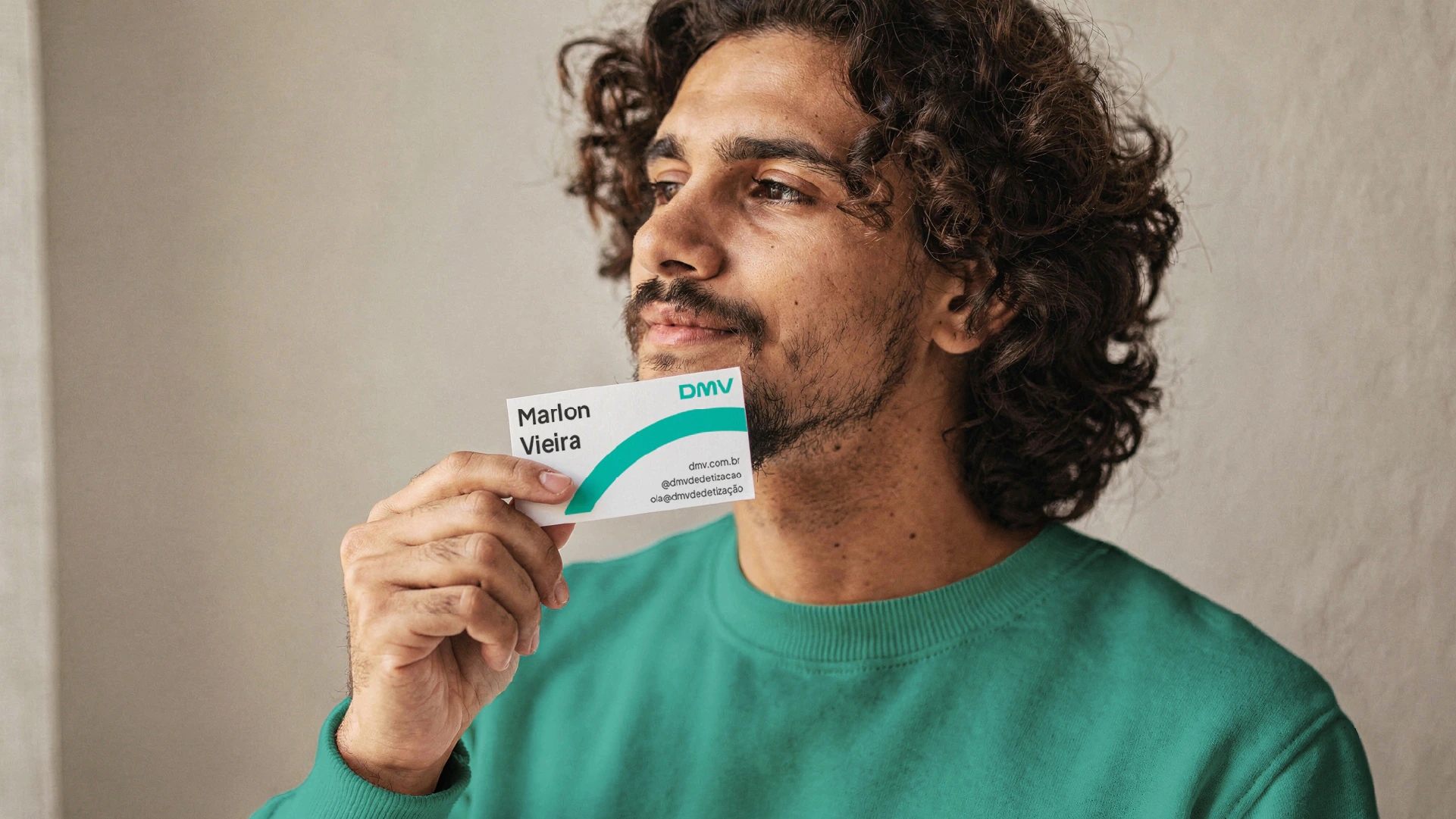 Man holding a DMV business card
